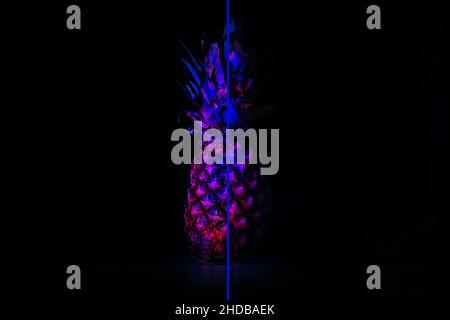 Metaverse digital Avatar, Metaverse Presence concept. Neon pineapple and it digital pixel reflection on black background. Pixel effect Stock Photo