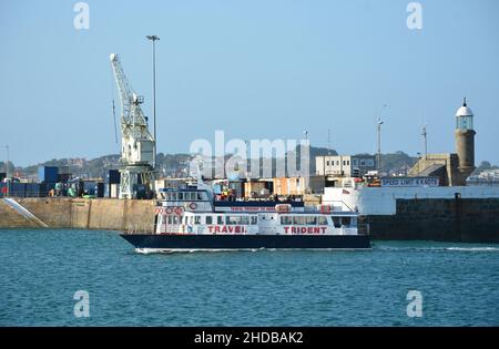 A Travel Trident passenger ferry to Herm Island arriving at St Peter Port, Guernsey, Channel Islands Stock Photo