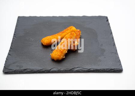 fish sticks, on cast iron plate isolated on white background Stock Photo