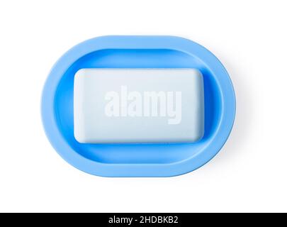 Soap on a dish isolated on white background. New rectangle soap bar on a rounded blue plastic holder for bathroom and shower. Washing hands with soap. Stock Photo