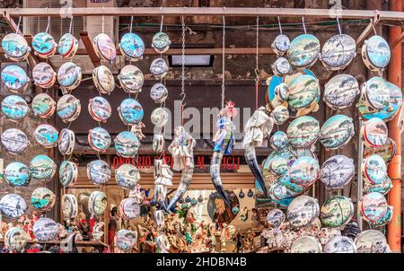 Naples, Italy - june 29 2021: tambourines hanging and displayed in a shop on the famous Via San Gregorio Armeno Stock Photo