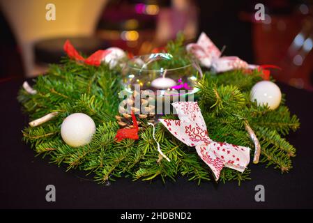 Closeup shot of a Christmas wreath on a dark surface Stock Photo