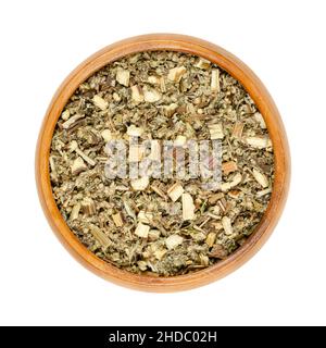 Mugwort herb in wooden bowl. Dried, cut common mugwort, Artemisia vulgaris, also riverside wormwood, felon herb, chrysanthemum weed or old Uncle Henry. Stock Photo