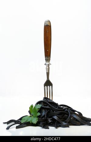 Black pasta with squid ink with fork, Tagliolini al Nero di Seppia, Italy Stock Photo