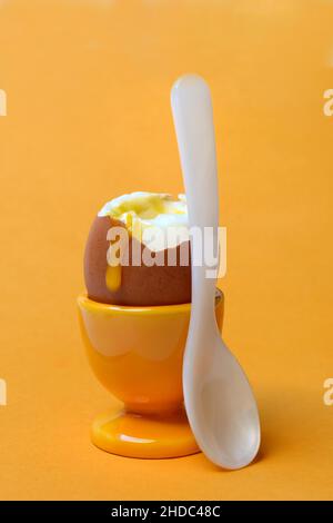 Soft boiled breakfast egg in egg cup with spoon Stock Photo