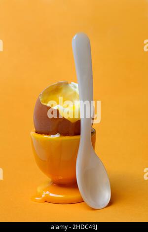 Soft boiled breakfast egg in egg cup with spoon Stock Photo