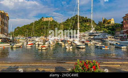 Boats and luxury yachts anchored in Portofino harbour, Brown Castle behind, Portofino, Liguria, Italy Stock Photo