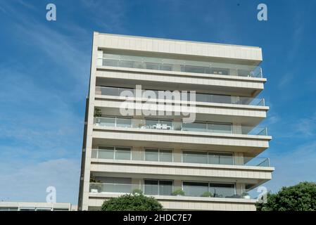 Shot of windows and balconies in the exterior design of a building under a cloudy sky Stock Photo