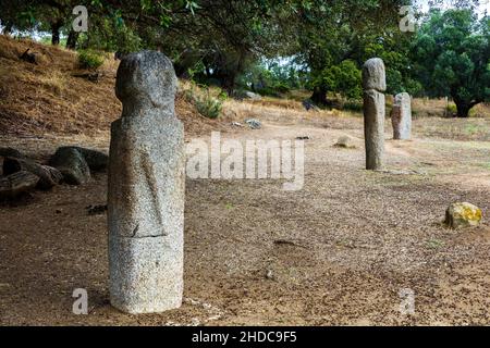 Menhir statues in the plain in front of a 1200 year old olive tree, Filitosa archaeological site, Corsica, Filitosa, Corsica, France, Europe Stock Photo