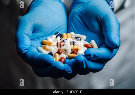 Doctor holding a lot of pills in his hands Stock Photo