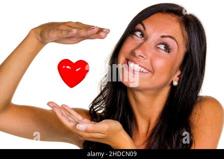 Eine verliebte junge Frau hält ein Herz in der Hand, 20, 25, Jahre, MR: Yes Stock Photo