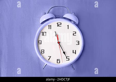 Retro style color alarm clock toned in Very Peri color - color of the year 2022 Stock Photo