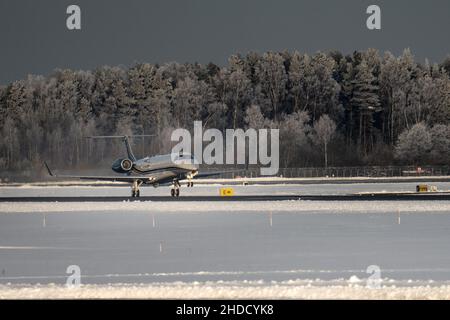 27-12-2021 Riga, Latvia Plane almost landed at the runway. Engine heat behind the plane. Stock Photo
