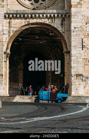 Lisbon, Portugal - January 5, 2022:Tuk tuks with tourists in front of the Se Cathedral in Lisbon, Portugal Stock Photo