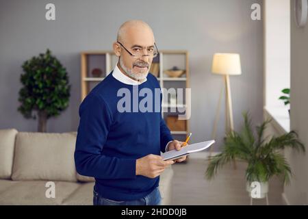 Portrait of old businessman in glasses posing in office Stock Photo