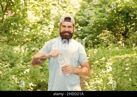 guy maintains body water balance. hydration. daily water. brutal bearded man drink bottle. Stock Photo