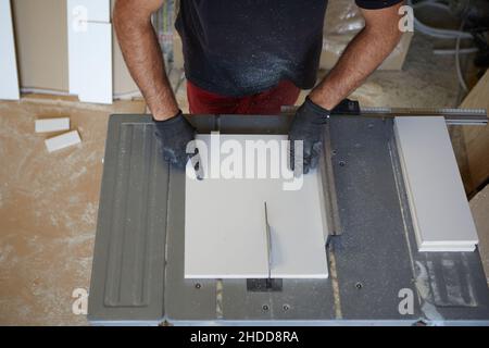 Top view of a man cutting a board on a table saw Stock Photo