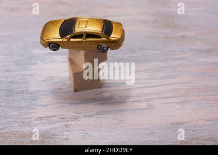 Gold toy car on a stack of wooden blocks Stock Photo