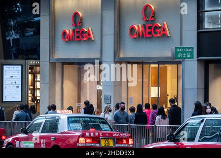 Pedestrians are seen walking past Swiss luxury watchmaker Omega store ...
