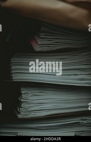 Vertical closeup shot of a large pile of paperwork Stock Photo