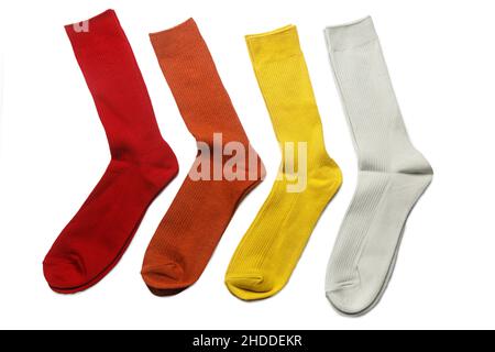 Four pairs of multi-colored socks: yellow, orange, gray, red are on a white background Stock Photo