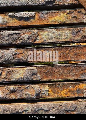 Rusty iron detail surface. Rusted and damaged scaffolding and corrosion. Close up and vertical background. Stock Photo
