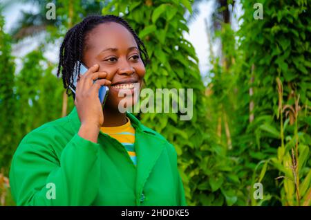 close up a pretty african lady in the farm making call Stock Photo