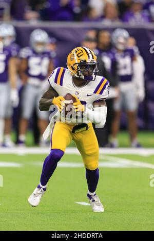 LSU Tigers quarterback Jontre Kirklin (13) rolls out as he looks to pass against the Kansas State Wildcats defense during the TaxAct Texas Bowl, Tuesd Stock Photo