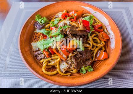 Lagman, typical meal of Central Asia, made of noodles, meat and vegetables. Stock Photo