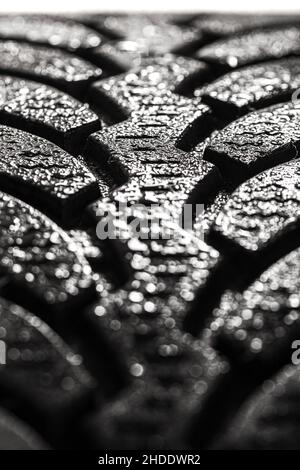 Abstract wet car winter tire. Rubber tyre cover patern with water drops. Stock Photo