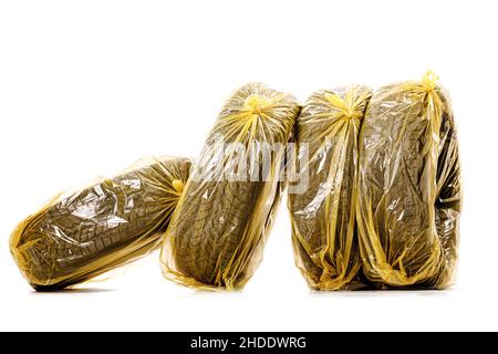 Car tires in yellow bags for storage. Set of four winter tyres isolated on white background. Stock Photo