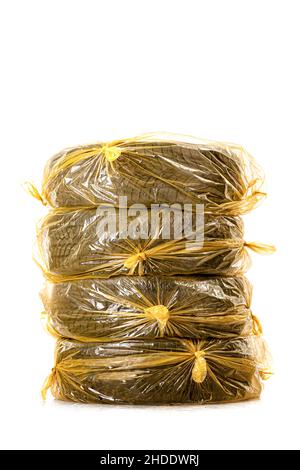 Car tires in yellow bags for storage. Set of four winter tyres isolated on white background. Stock Photo