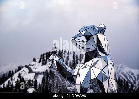 Mount Sulfur, Canada - Dec. 22 2021: Crystal Bear statue with background of Mount Sulfur Stock Photo