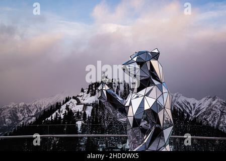 Mount Sulfur, Canada - Dec. 22 2021: Crystal Bear statue with background of Mount Sulfur Stock Photo