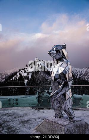 Mount Sulfur, Canada - Dec. 22 2021: Crystal Bear statue with background of Mount Sulfur Stock Photo