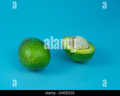 avocado on blue background. healthy fruit concept. Stock Photo