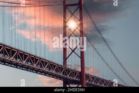 Lisbon, Portugal-October 17, 2021: Landmark suspension 25 of April bridge over Tagus River in Lisbon Stock Photo