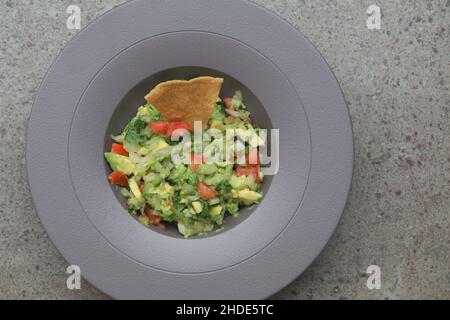 Guacamole pico de gallo dish with a corn chip Stock Photo