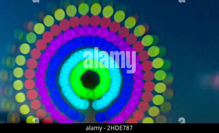 Blurred colorful colored circles, night view ferris wheel impression.  taken out of focus for use as a colourful background. Stock Photo