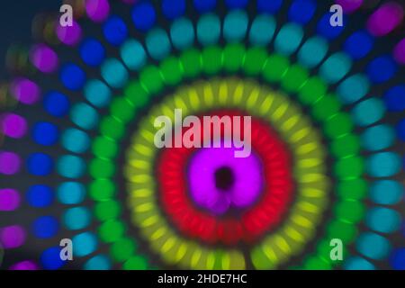 Blurred colorful colored circles, night view ferris wheel impression.  taken out of focus for use as a colourful background. Stock Photo