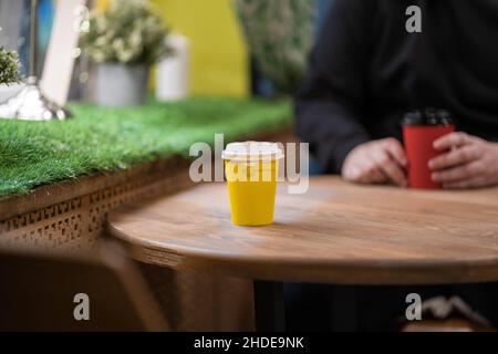Two disposable cups of coffee on the table. Stock Photo