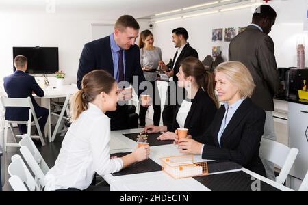 business people chatting while enjoying coffee Stock Photo