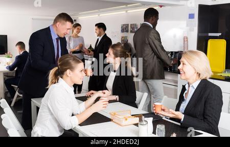 business people chatting while enjoying coffee Stock Photo