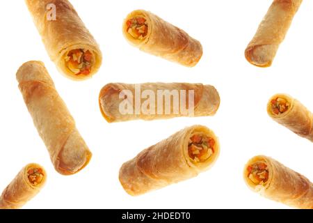 Vegetable spring rolls flying on isolated white background full and cut. Stock Photo