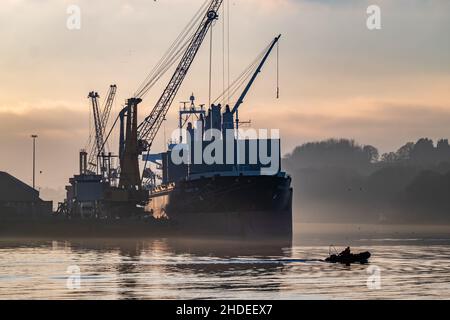 DERRY, LONDONDERRY, UNITED KINGDOM - December 19 2021: Staff working on the river foyle harbour in Northern Ireland. Stock Photo