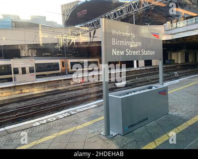 Welcome to Birmingham New Street Station and Bull ring Birmingham train track line commuter bridge platform train sign signs building Network rail Stock Photo