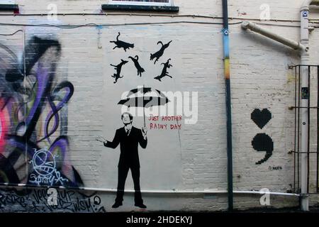 just another rainy day graffiti art of man in black suit at burnham on sea somerset england UK Stock Photo