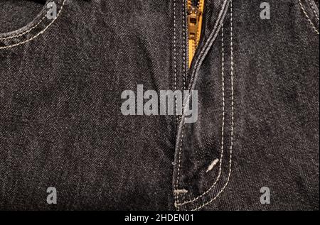 Zipper on black denim trousers with double stitching close-up. Front view Stock Photo