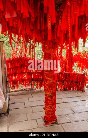Red blessing ribbons tied on railings and branches in Wulingyuan Scenic ...