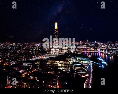 Stunning panorama view over Thames river in night the Shard, the London skyline and cityscape. Aerial photo over the big city. Stock Photo